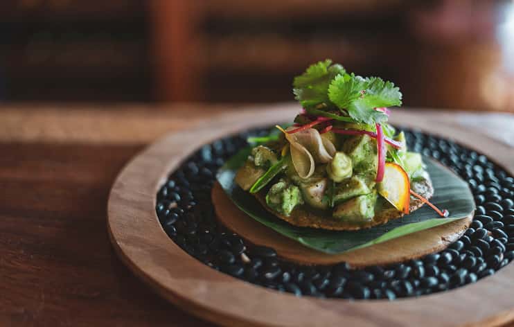 Ana y Jose rustic restaurant, communal table, thatched roof, tropical dining, hanging lights