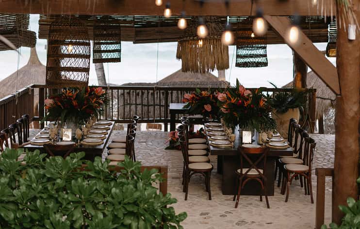 Ana y Jose rustic restaurant, communal table, thatched roof, tropical dining, hanging lights