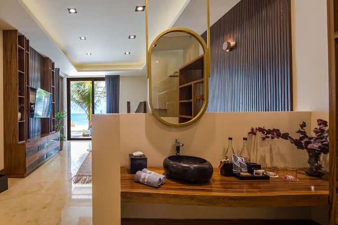 Casa Agua Ana y Jose elegant bathroom, stone sink, round mirror, organic design